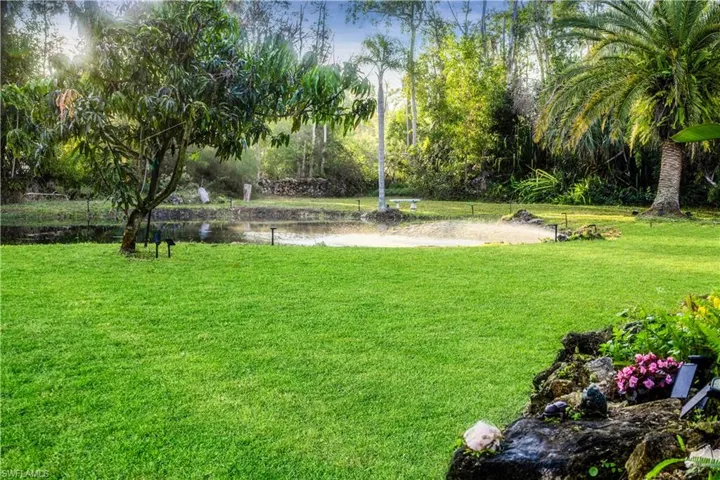 View of yard featuring a water view of front pond