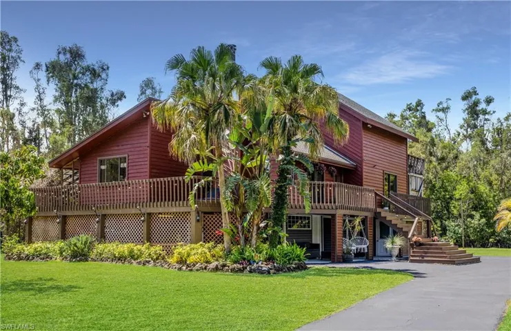 View of front facade featuring a front lawn and a deck