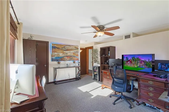 Carpeted office with ceiling fan