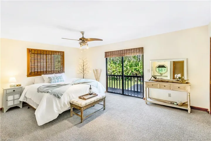 Bedroom featuring access to outside, carpet, and ceiling fan