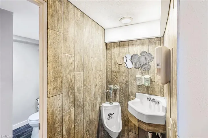 Bathroom featuring a textured ceiling, sink, and toilet