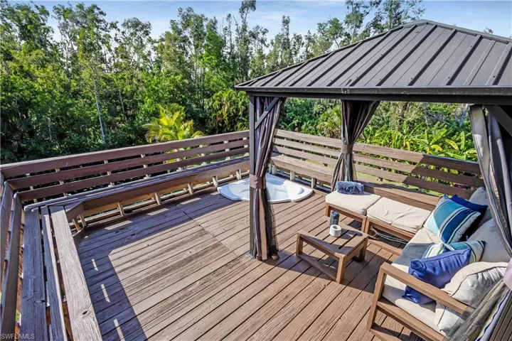 Wooden deck featuring outdoor lounge area and a gazebo