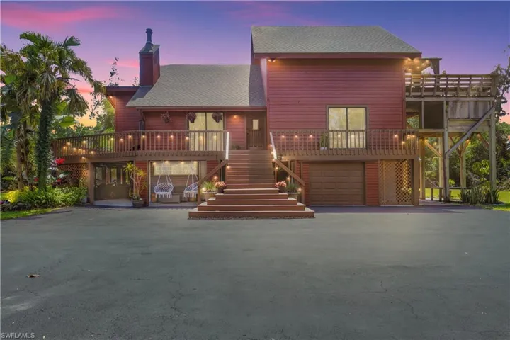 View of front of house featuring a garage and a carport