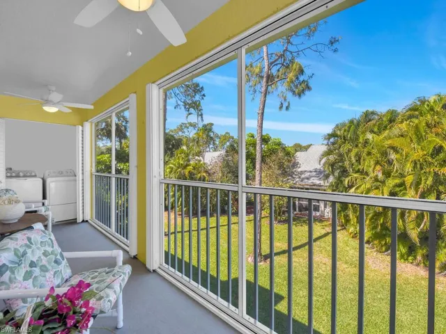 Sunroom featuring carpet floors and washing machine and clothes dryer