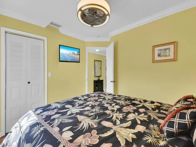 Bedroom featuring crown molding and a closet