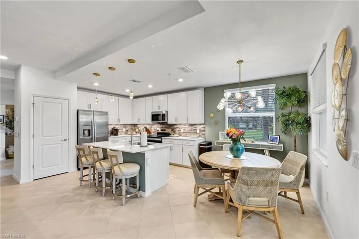 BEAUTIFUL BLUISH GRAY BACKSPLASH WITH CUSTOM WALLPAPER IN EAT IN KITCHEN