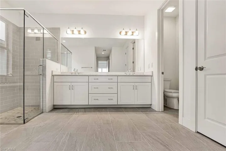 Primary bathroom with quartz countertops and soft-close cabinetry