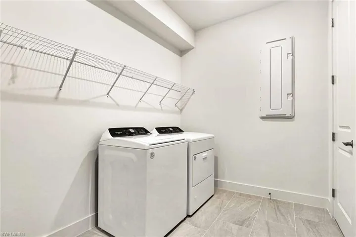 Laundry room with washer and gas dryer and wire shelving
