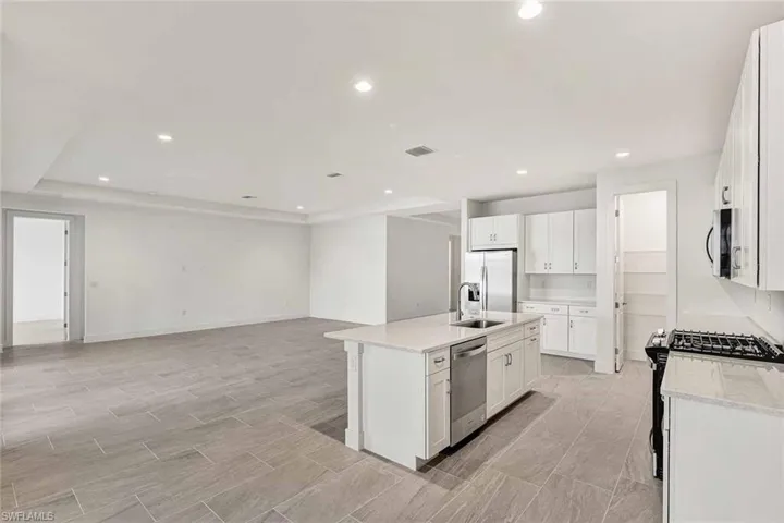 Great room living area with tray ceiling