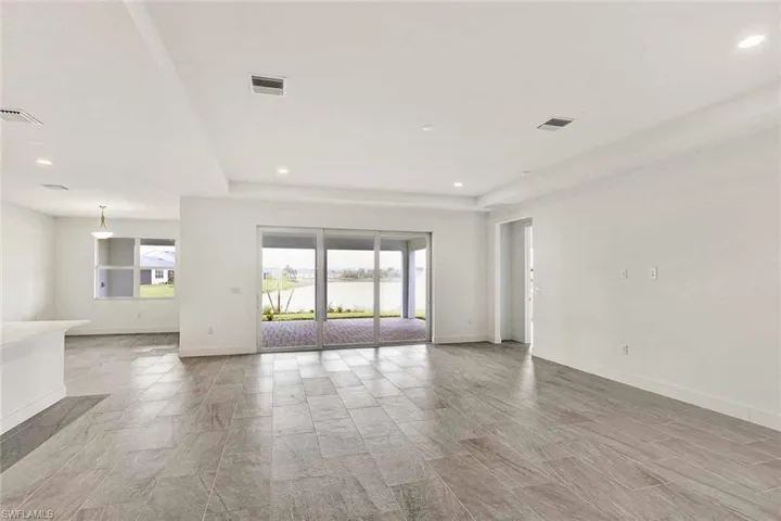 Great room living area with tray ceiling