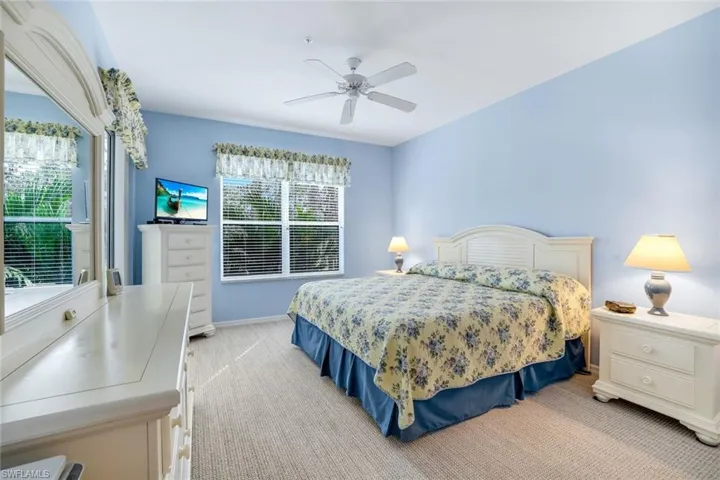 Bedroom featuring a ceiling fan and light carpet