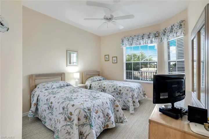 Bedroom featuring a ceiling fan and carpet