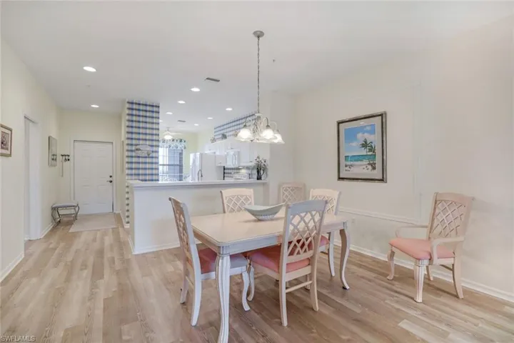 Dining room featuring recessed lighting, light wood-type flooring, and a chandelier