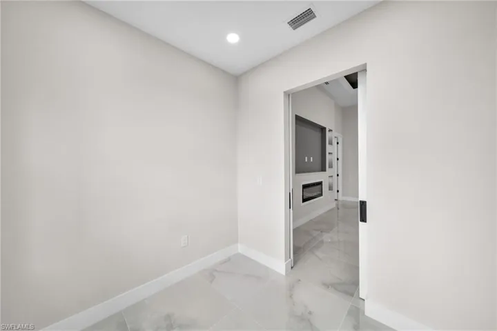Hall featuring tile patterned floors