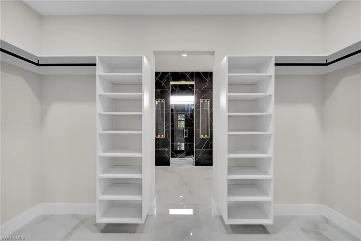 Walk in closet with tile patterned flooring