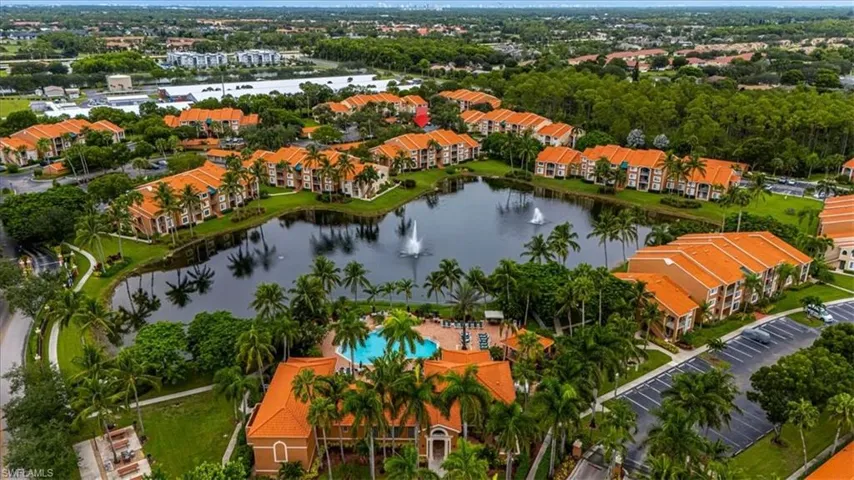 Aerial view of property and surrounding area with apartment complex and a large body of water