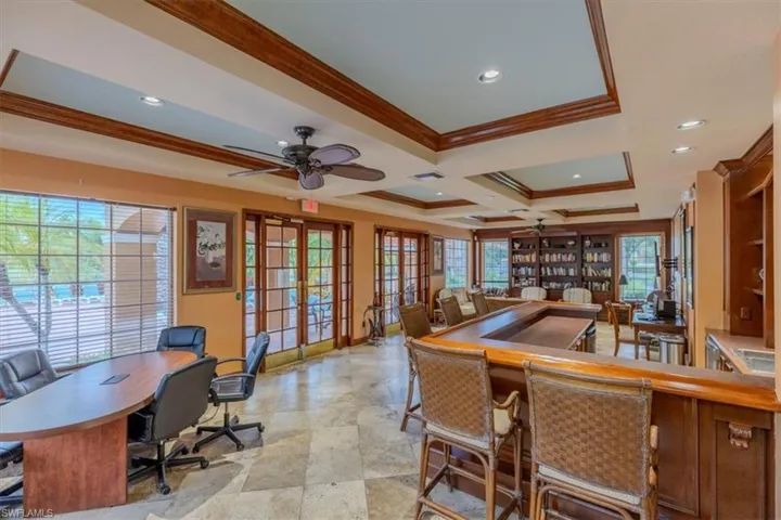 Office area with french doors, ceiling fan, crown molding, recessed lighting, and coffered ceiling