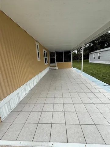 View of covered parking leading to  a Florida Room.