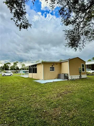 Rear view of property with a yard.