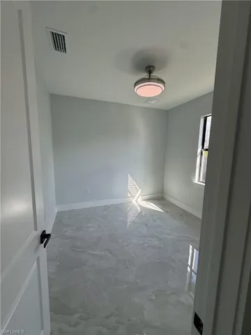 Empty room featuring baseboards
