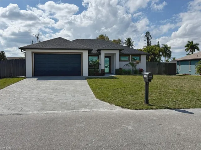 View of front of property featuring decorative driveway, stucco siding, a garage, and roof with shingles
