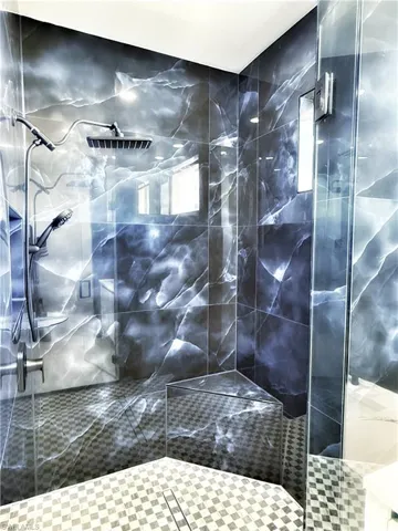 Full bathroom with a marble finish shower