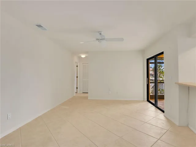 Spare room featuring light tile patterned floors and ceiling fan