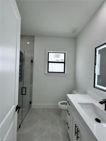 Bathroom with vanity and a shower stall