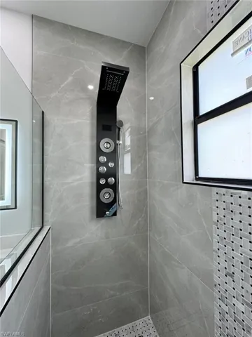 Bathroom with tiled shower and elevator