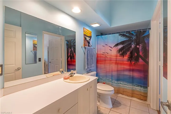 Bathroom with light tile patterned floors and vanity