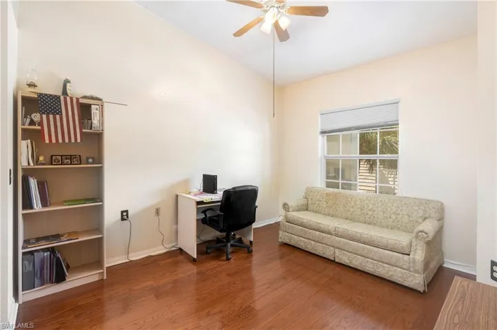 Office area with wood finished floors and a ceiling fan