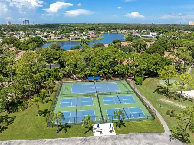 Drone / aerial view of a tree filled landscape and a large body of water