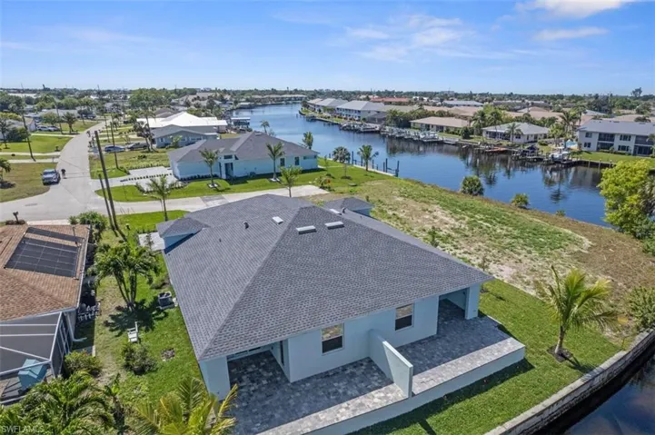 Birds eye view of property featuring a water view and a residential view