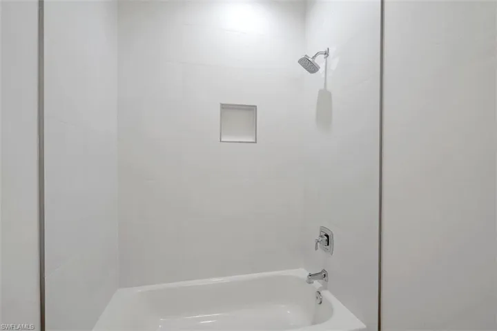 Bathroom with shower / washtub combination