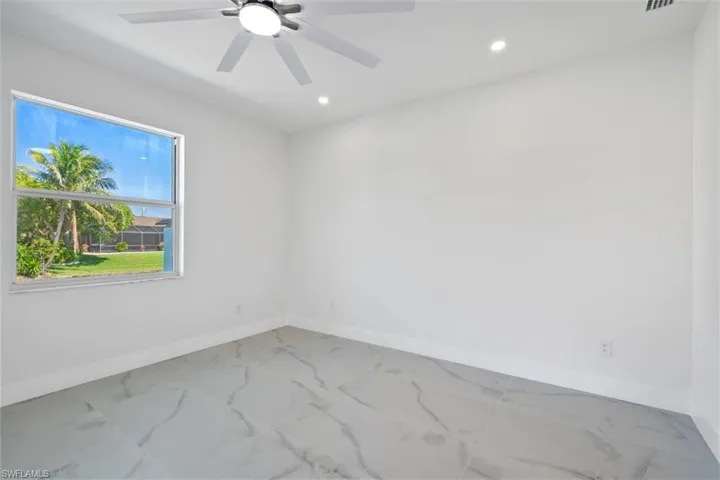 Spare room featuring marble finish floor, recessed lighting, baseboards, and ceiling fan