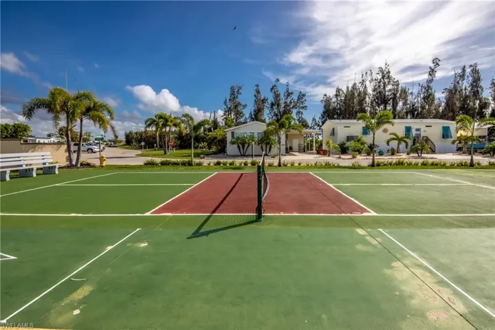 View of tennis court with community basketball court