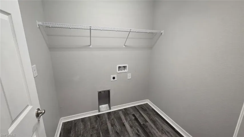 Washroom with dark wood finished floors, electric dryer hookup, and hookup for a washing machine