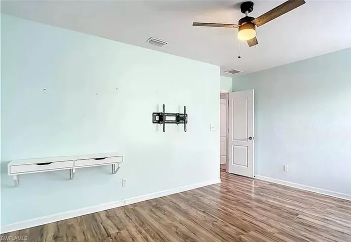 Unfurnished bedroom featuring a closet, ceiling fan, and hardwood / wood-style floors