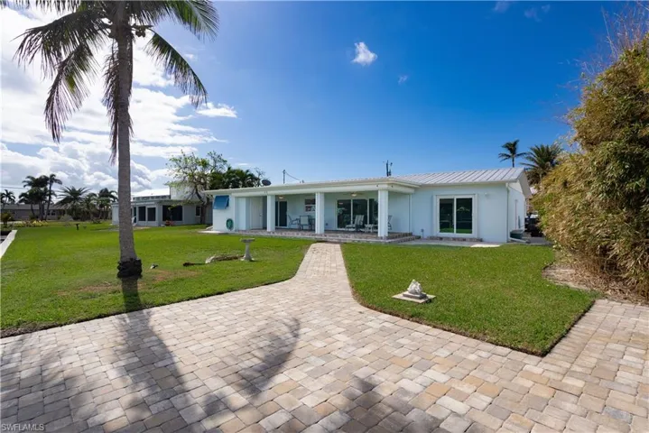Back of house with a lawn