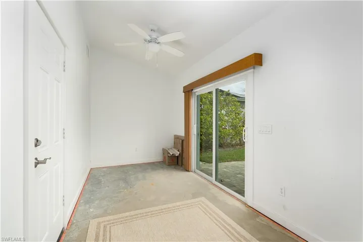 Den featuring ceiling fan