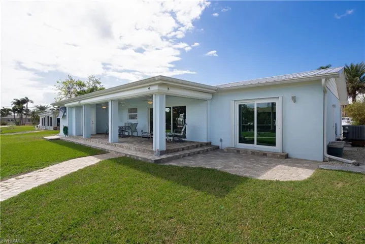 Rear view of property with a patio area, ceiling fan, a yard, and cooling unit