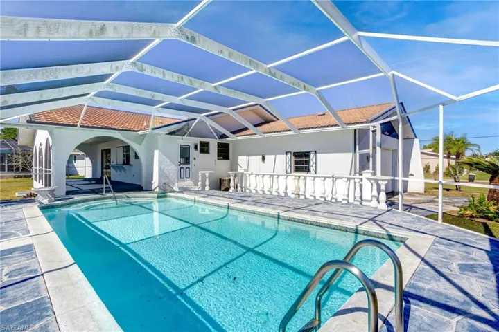 View of swimming pool featuring a patio and a pool cage