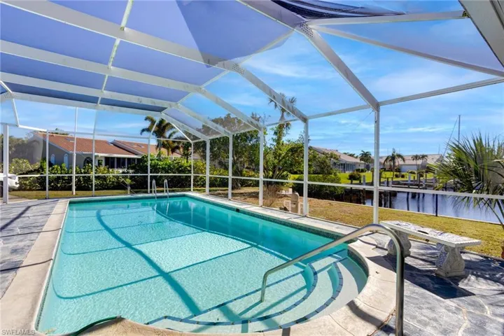 View of screened in swimming pool from patio