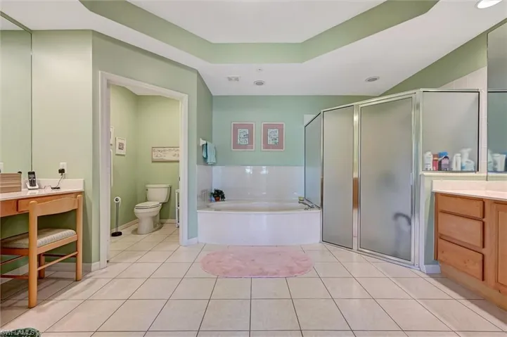 Spacious Attached Bathroom featuring bath soaking tub and shower.