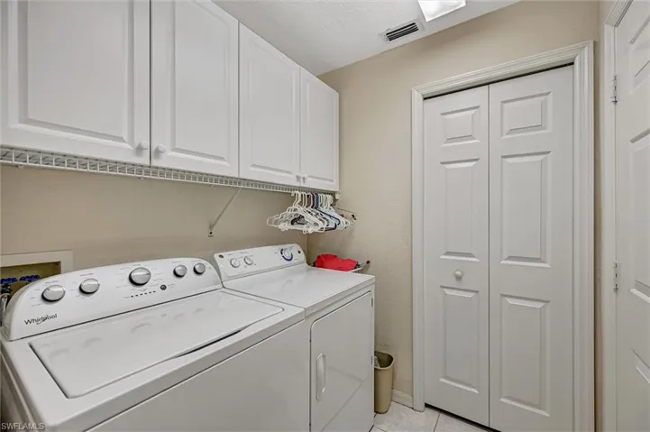 Laundry room with cabinet space.
