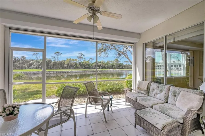 Sunroom / solarium featuring ceiling fan, a water view, and a healthy amount of sunlight