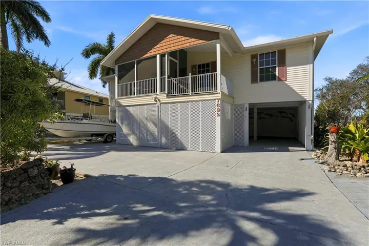 Paved parking and entrance to under home parking and storage