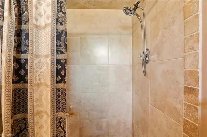 Bathroom view of a tile shower