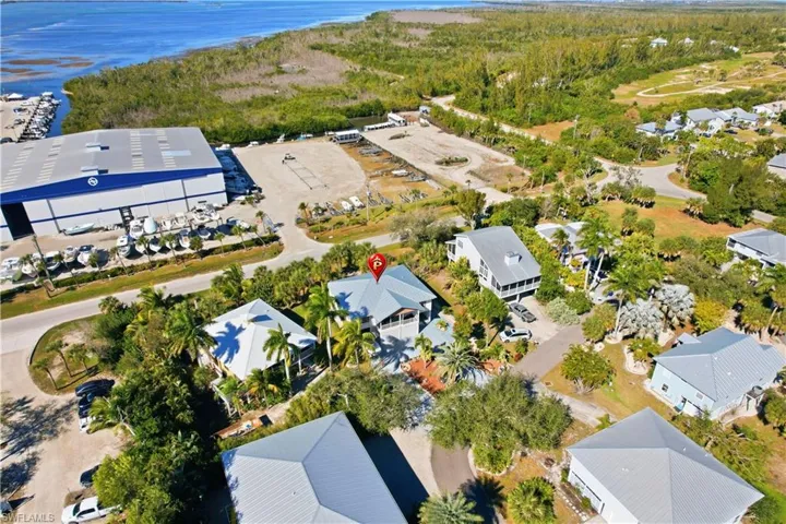 Aerial view of property and surrounding area featuring a nearby body of water