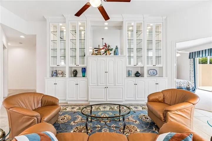 Tiled living room featuring ceiling fan